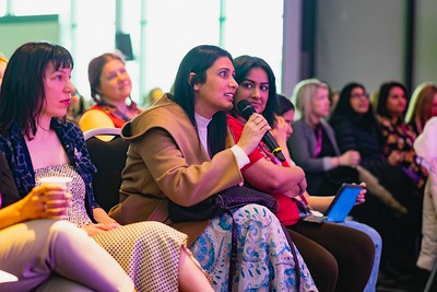 Women talking into a microphone at an event