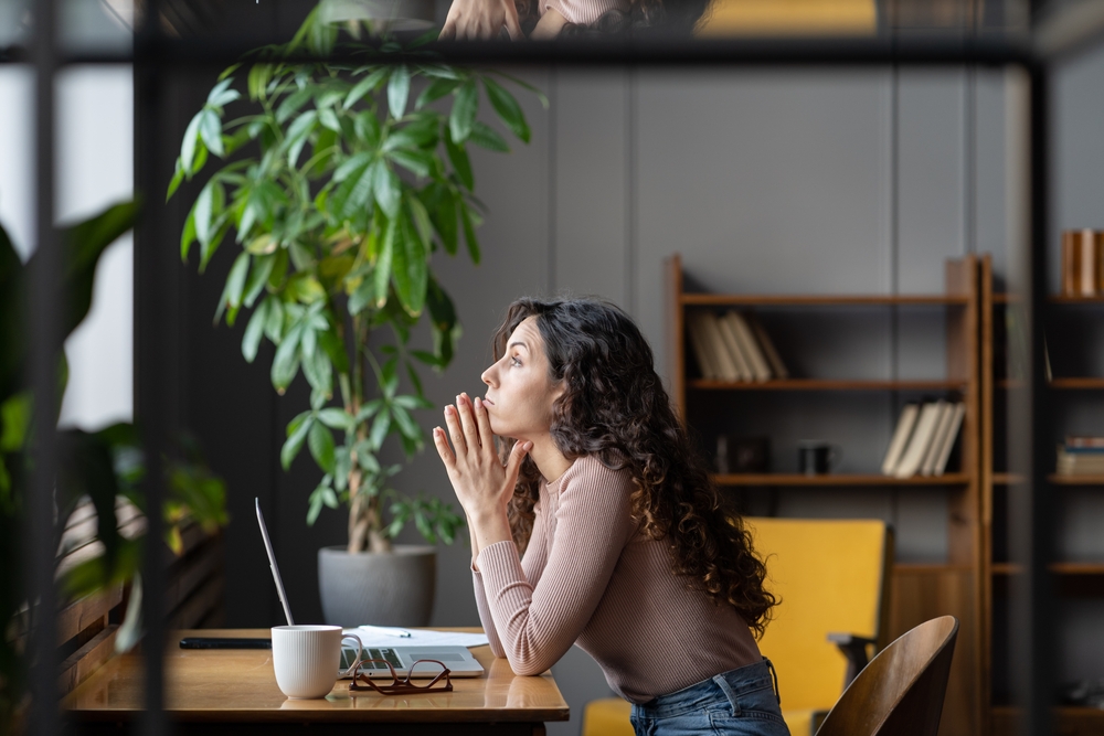 challenges facing women in tech image of woman at laptop looking sad
